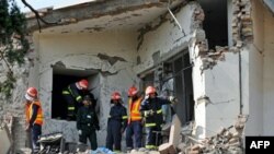 Rescuers search for victims after the attack against police in Islamabad.