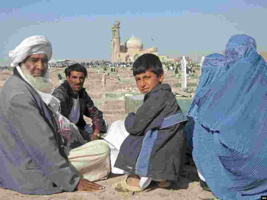 An Afghan family visits the graves of their relatives at the shrine of Sultan Aqa in Herat - Noruz08 Caption: epa01292003 An Afghan family visit graves of their relatives as they celebrate the Persian New Year Noruz, at the Shrine of Sultan Aqa in Herat, western Afghanistan 20 March 2008 Noruz08