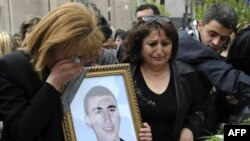 Relatives of a protester killed in the postelection violence lay flowers in his memory in Yerevan in April 2008