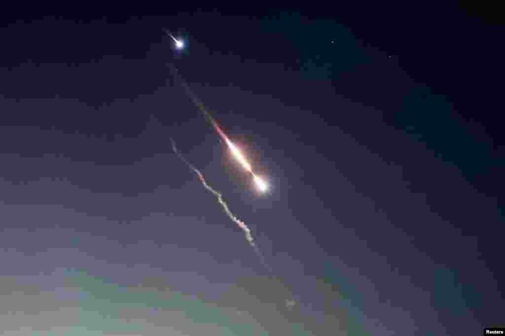 Objects are seen in the sky above Jerusalem after Iran launched drones and missiles toward Israel.