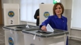 Moldovan President Maia Sandu casts her vote at a polling station during the country's parliamentary elections in Chisinau on September 28.