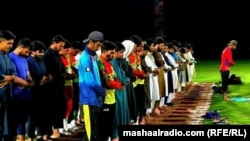 Players offering prayer in a cricket stadium that was later bit by blasts. 