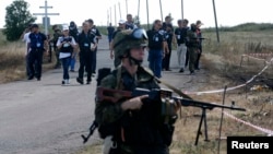 Ukraine -- Monitors from the OSCE and members of a forensic team visit the crash site of Malaysia Airlines Flight MH17 near the village of Hrabove, Donetsk region, July 21, 2014