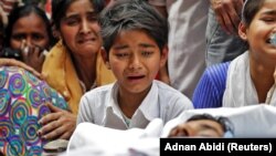 People mourn next to the body of Muddasir Khan, who was wounded in a clash between people demonstrating for and against a new citizenship law, after he succumbed to his injuries, in a riot-affected area in New Delhi, February 27, 2020