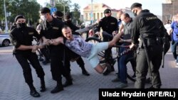 Police detain a protester at a rally in Minsk on June 19. 