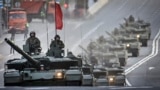 Russian T-90M tanks travel through central Moscow during a rehearsal for the Victory Day parade where Russia will celebrate the 80th anniversary of the 1945 defeat of Nazi Germany, on May 3, 2025.