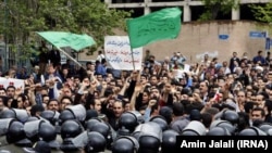 Iranian police try to stop protesters in front of the Saudi Embassy in Tehran in 2015.