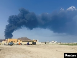 Smoke rises in the Fujairah oil industry zone after a drone incident on March 14 that resulted in a temporary suspension of operations. The facility has not been hit again, according to reports.