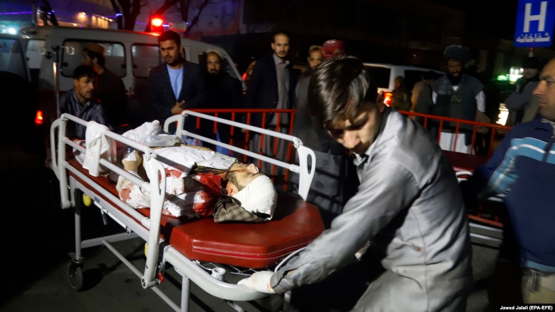 Afghan health workers bring an injured person to the hospital after a suicide attack targeted a wedding hall, in Kabul on November 20.